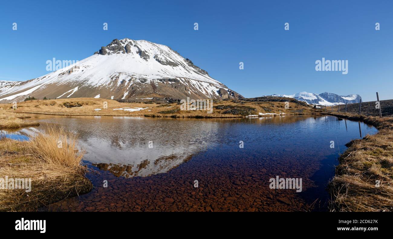 Snowcapped mountain reflecting in lake, Iceland Stock Photo