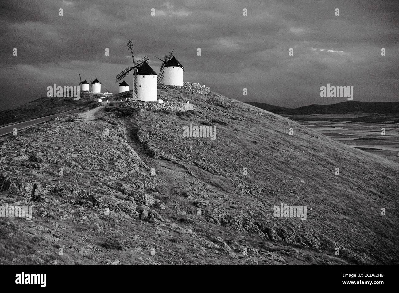 Old historic windmills on hill in black and white, Consuegra, Castilla La Mancha, Spain Stock Photo