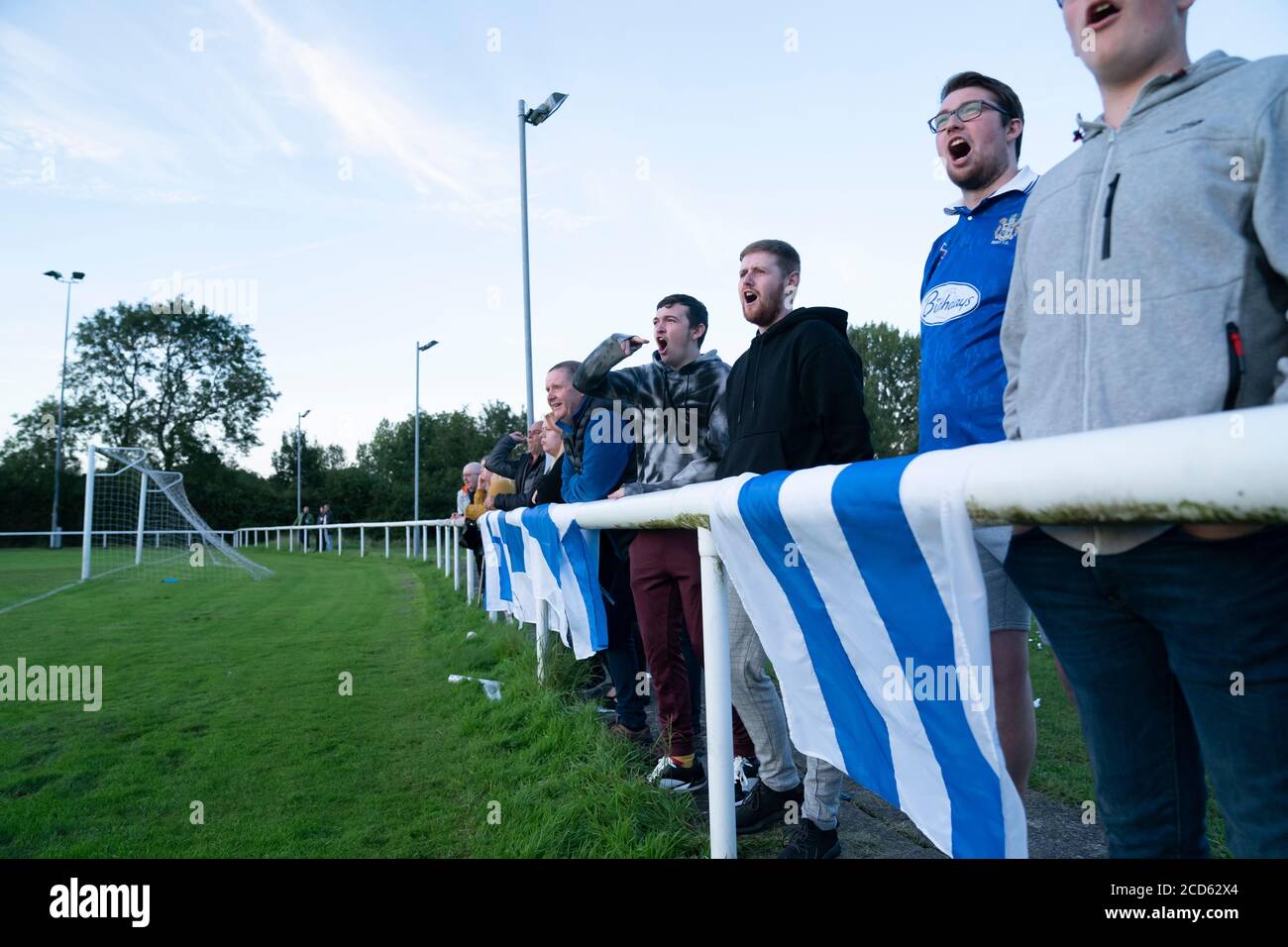 Bolton, UK. 26th August, 2020. Bury AFC supporters watch their teamÕs first competitive game in public, a Challenge match away to fellow North West Counties First Division North side Daisy Hill in the Westhoughton area of Bolton, UK. The Shakers phoenix club have played training games but it was announced on Monday that fans will be able to attend the game. Credit: Jon Super/Alamy Live News. Stock Photo