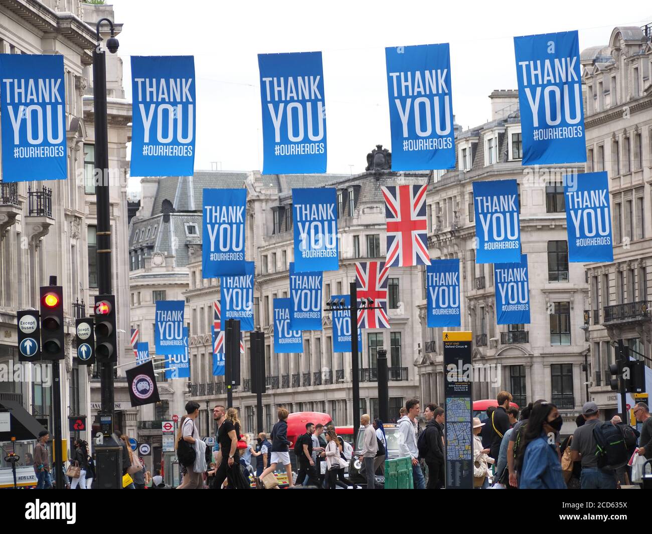View looking along lines of many flags hanging above Regent Street in London thanking our heroes during the Covid 19 pandemic in 2020 Stock Photo