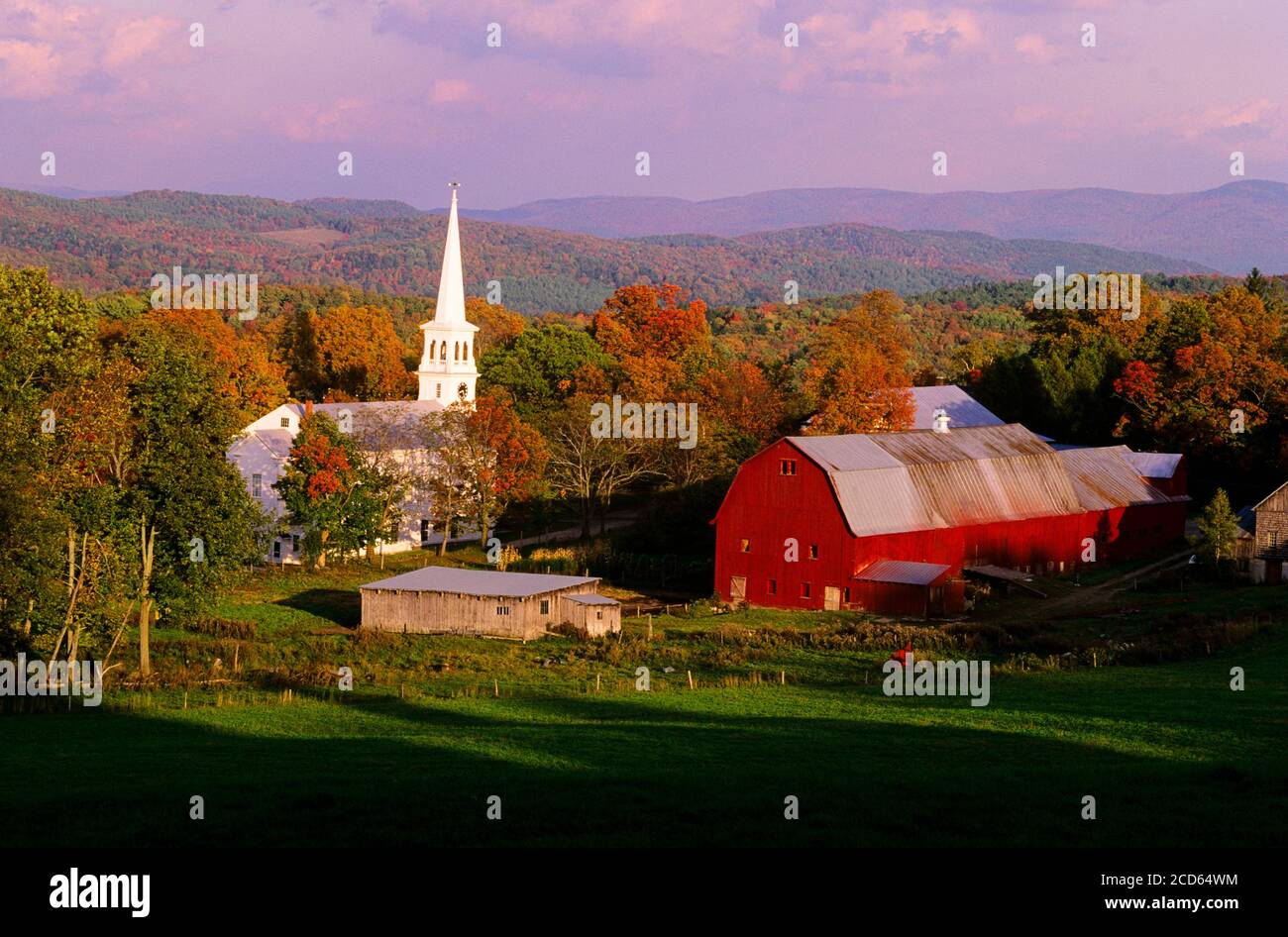 Church and barn in town in autumn, Peacham, Vermont, USA Stock Photo