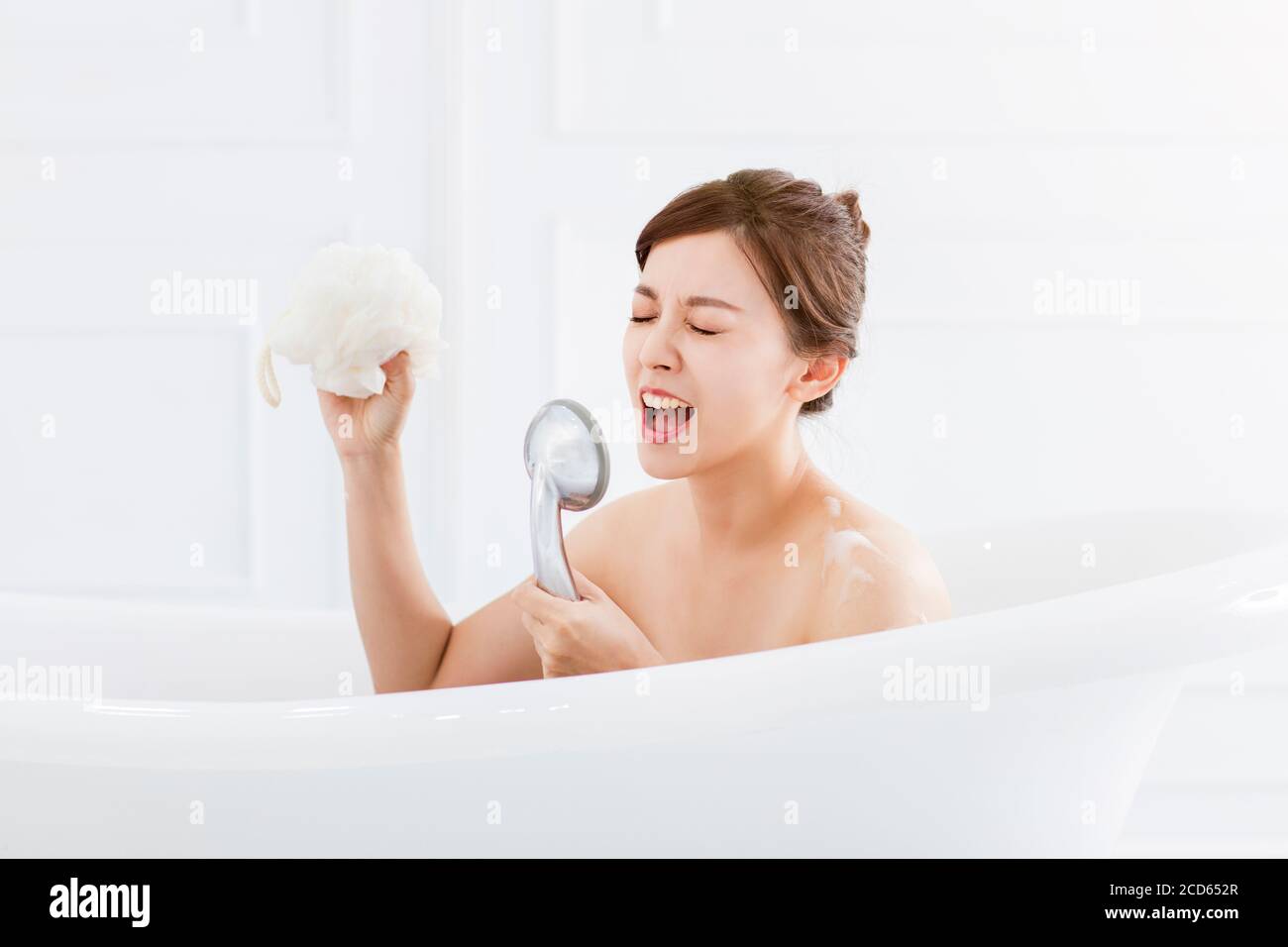 young woman take a bath and singing in the bathtub Stock Photo Alamy