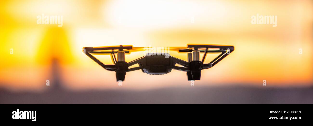Drone flying outside in sky sunset banner panorama. Closeup of drone