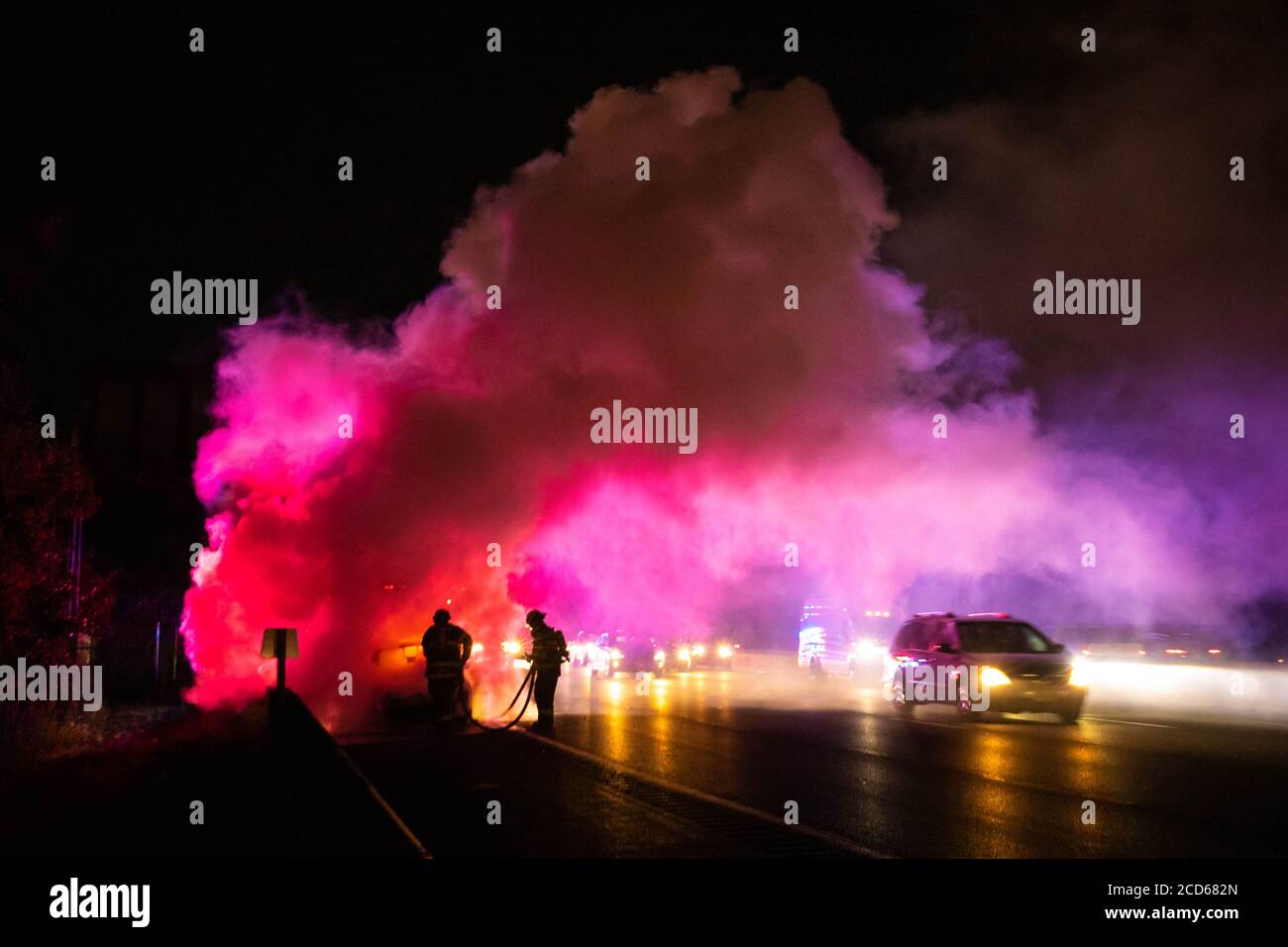 Car on fire night accident on the highway road with police Stock Photo