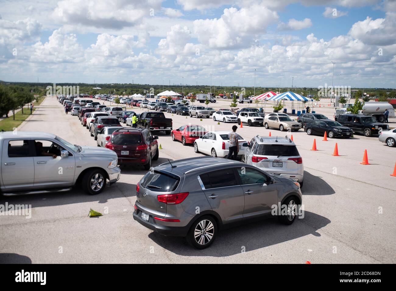 Austin, TX USA August 26, 2020: Hundreds of cars from coastal east Texas and southwest Louisiana wait in line at a Hurricane Laura evacuation center set up by Austin officials at the Circuit of the Americas race track parking areas. Early-arriving drivers received vouchers for hotel rooms. Once those ran out, drivers were directed to other evacuation centers in Waco and Dallas. Laura is expected to make landfall overnight as a Category 4 storm and wreak havoc along the Texas and Louisiana coasts and inland. Credit: Bob Daemmrich/Alamy Live News Stock Photo