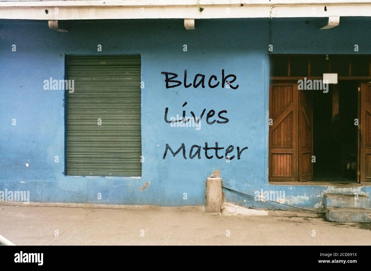 Black Lives matter written on blue wall in a rural area of africa Stock Photo