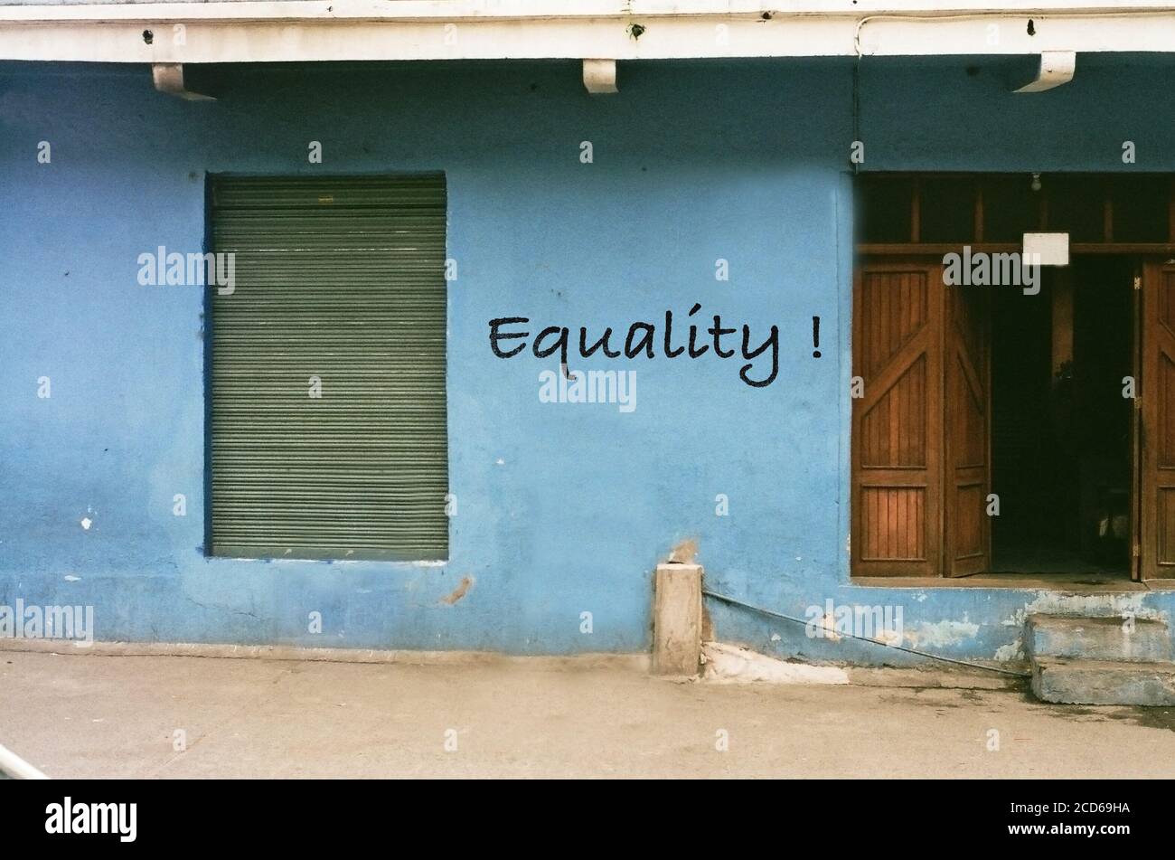 Equality ! written on blue wall in a rural area of africa Stock Photo