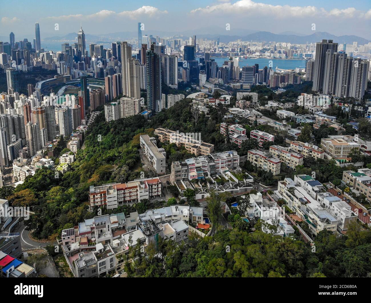 An aerial photograph taken above Mount Butler, Hong Kong, looking towards Happy Valley, Causeway Bay and Victoria Harbour. Stock Photo