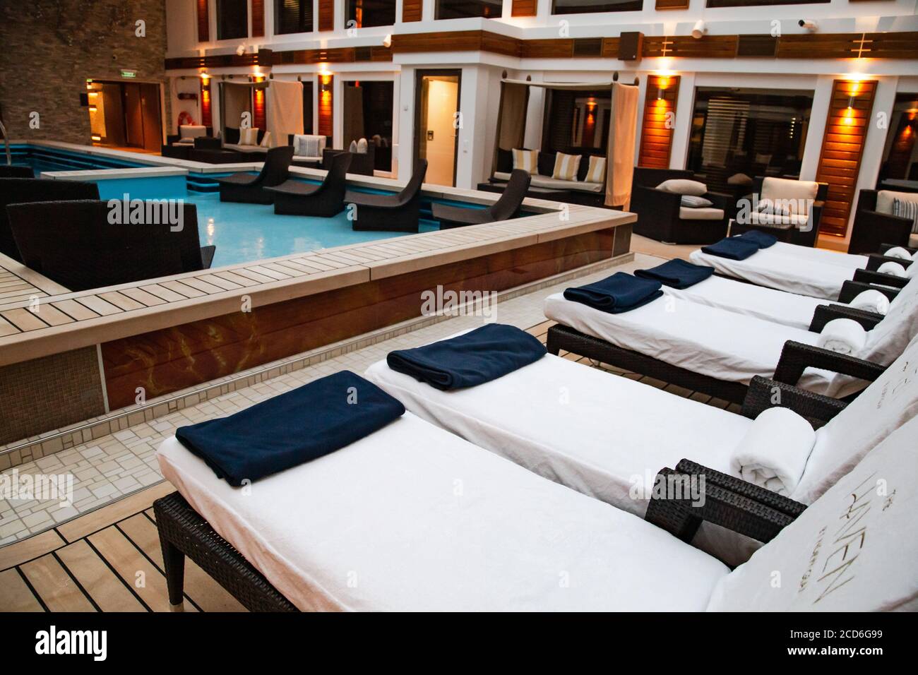 The Haven courtyard has a pool, hot tubs and lounge chairs in exclusive area on board the Norwegian Joy NCL cruise ship Stock Photo