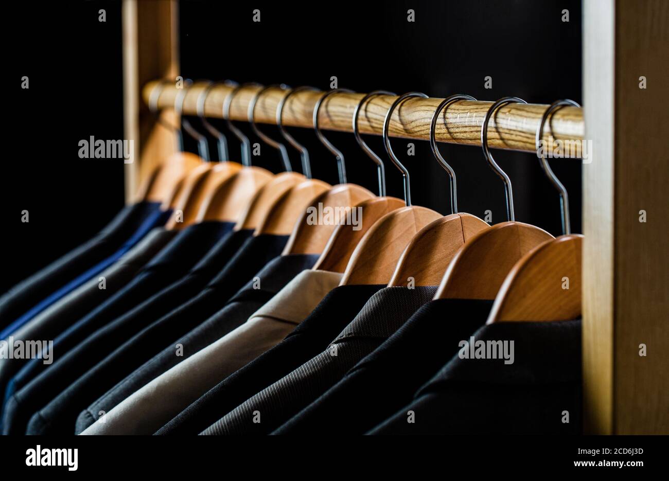 Mens shirts, suit hanging on rack. Hangers with jackets on them in