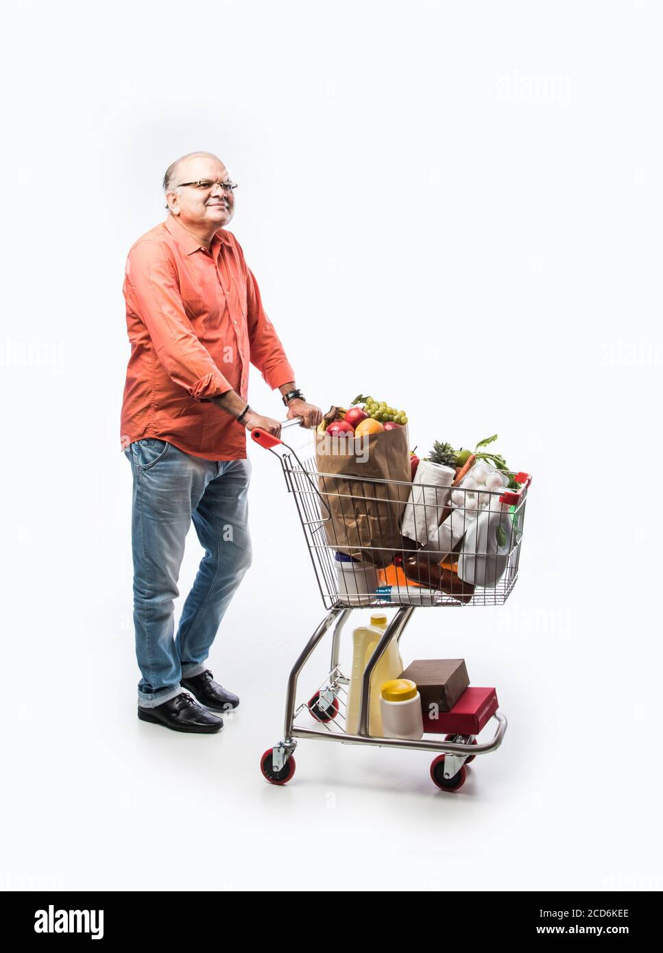 Indian old man with shopping cart or trolly full of vegetables, fruits