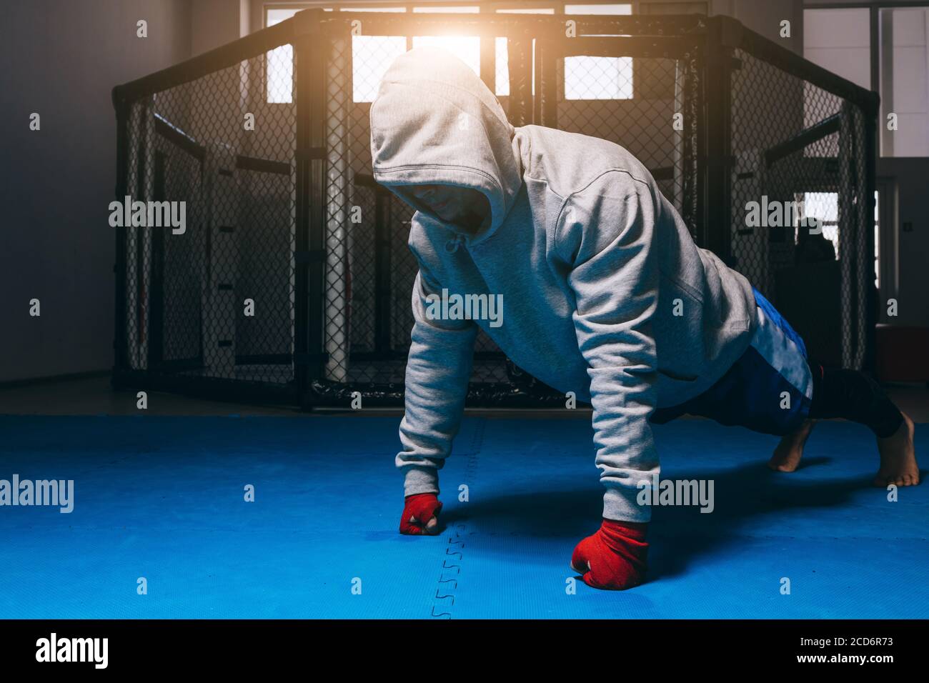 Unrecognizable guy in sports hoodie doing push-ups on fists. Sport workout  bodybuilding motivation concept Stock Photo - Alamy