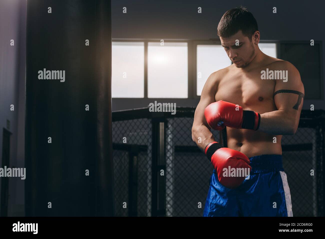 Young athletic man preparing for boxing competitions, training defense ...