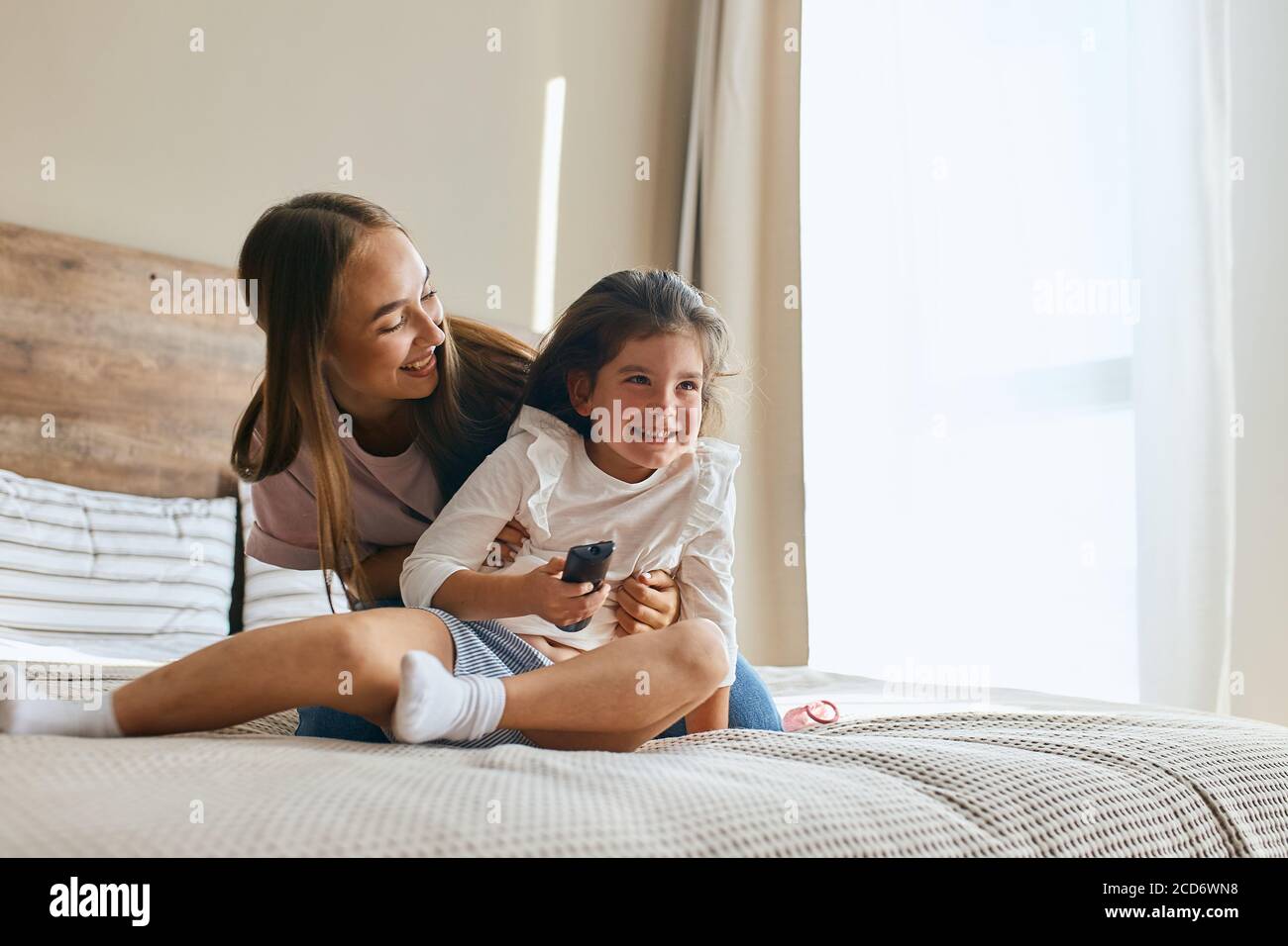 Young mother with her five years old little daughter dressed in casual