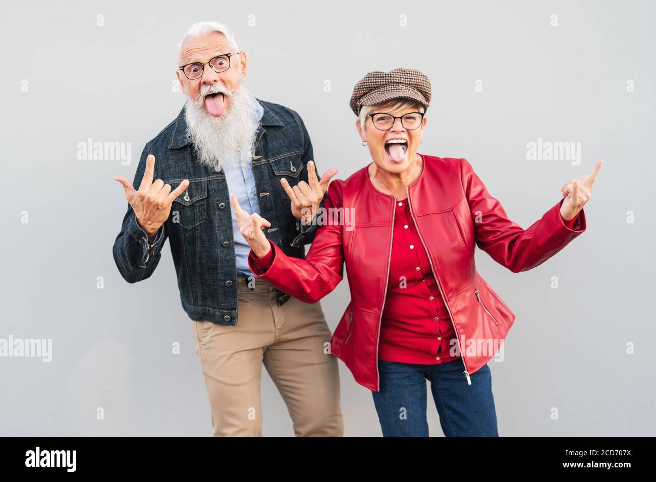 Happy senior couple having fun together outdoor - Retired man and woman celebrating crazy moments Stock Photo