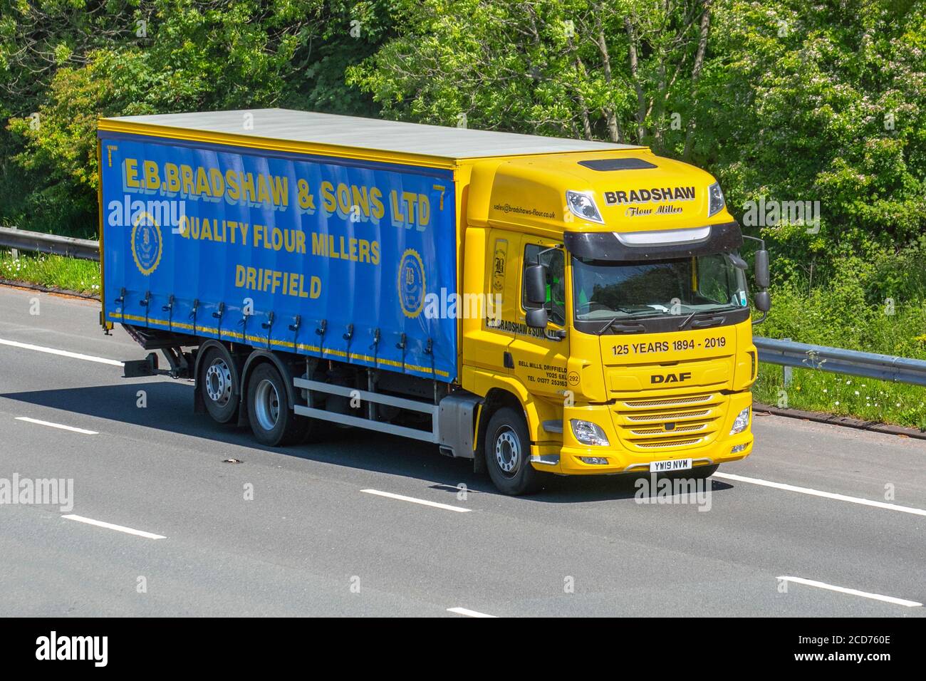 Eb Bradshaw & Sons Ltd; Haulage delivery trucks,Flour Millers lorry, transportation, truck, cargo carrier, yellow DAF CF vehicle, European commercial transport industry HGV, M6 at Manchester, UK Stock Photo