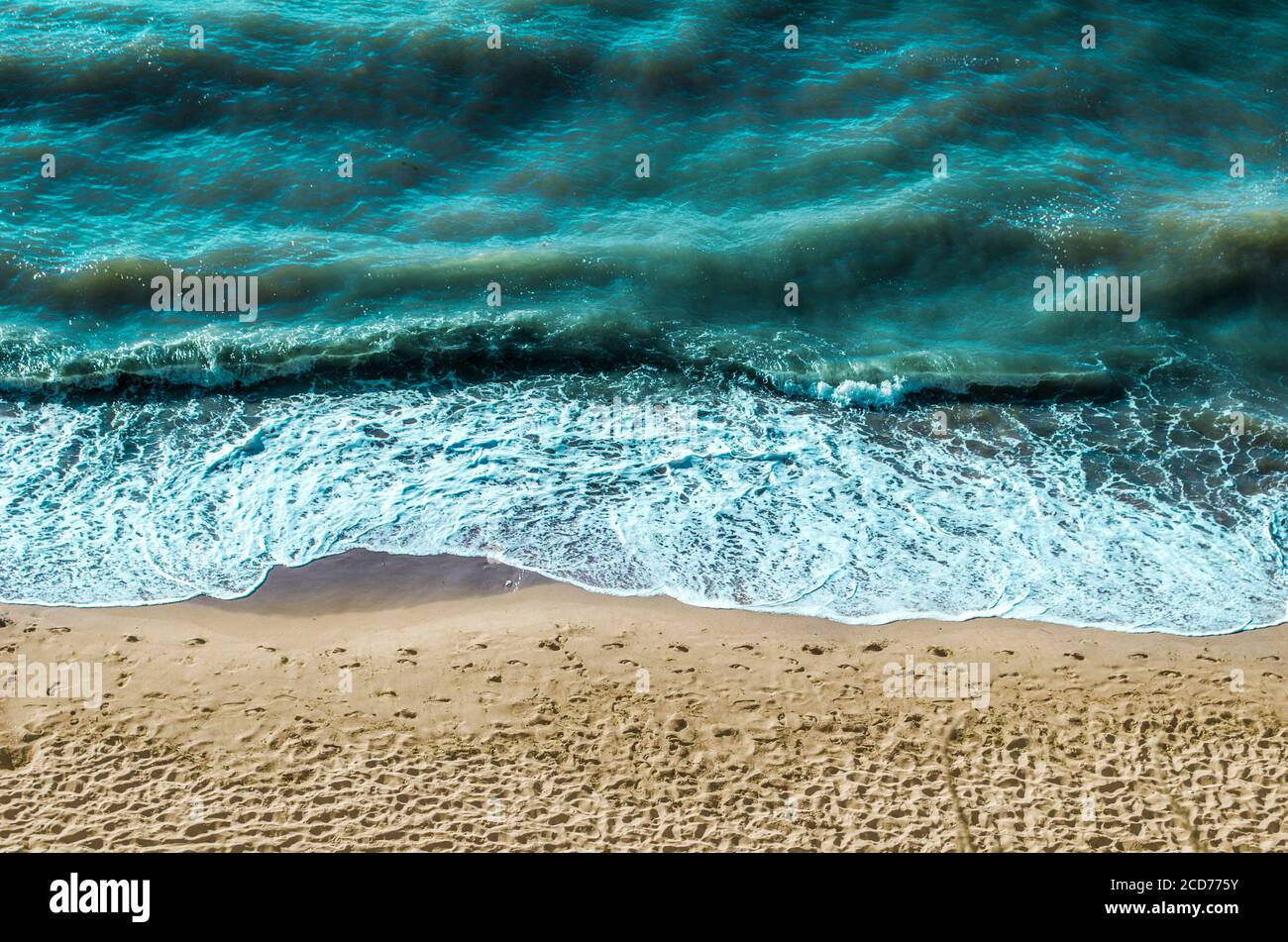 Sea sand, footprints in the sand, foam top view. Horizontal seascape ...