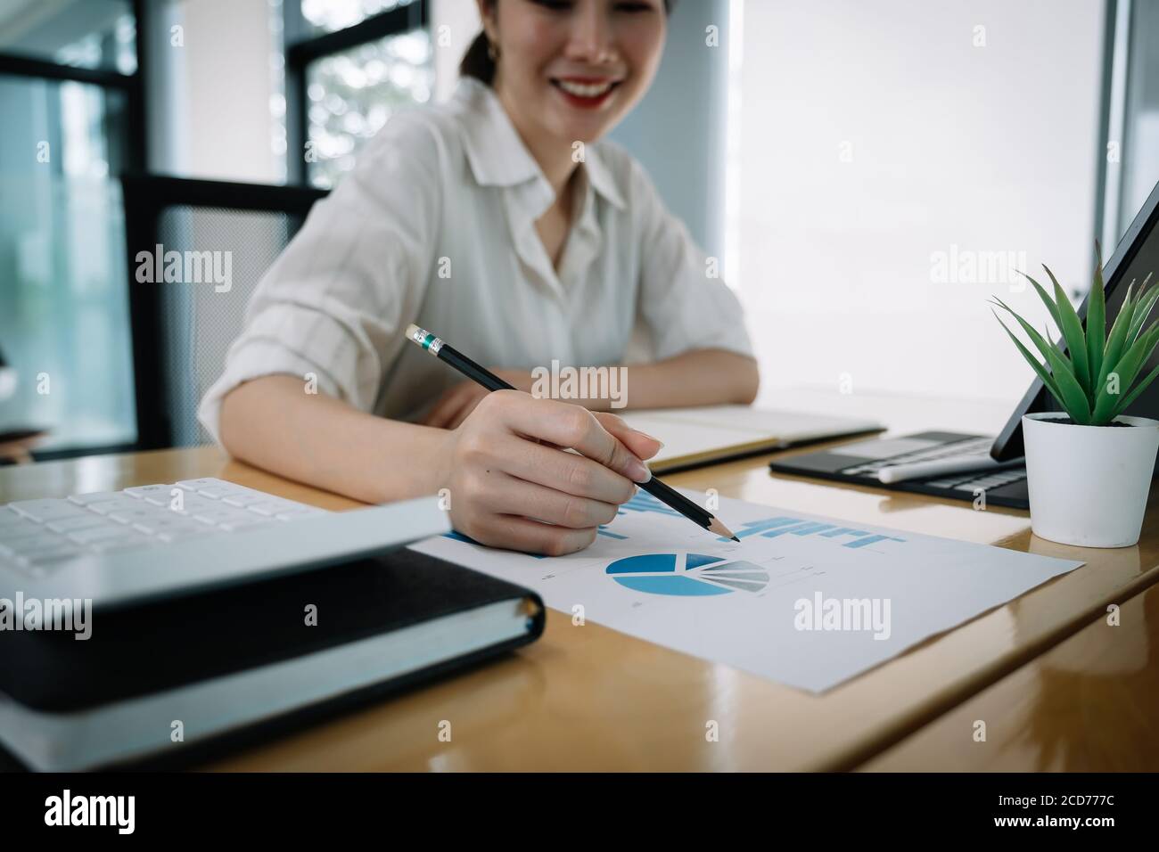 usiness man investment consultant analyzing company annual financial report balance sheet statement working with documents graphs. Concept picture of Stock Photo