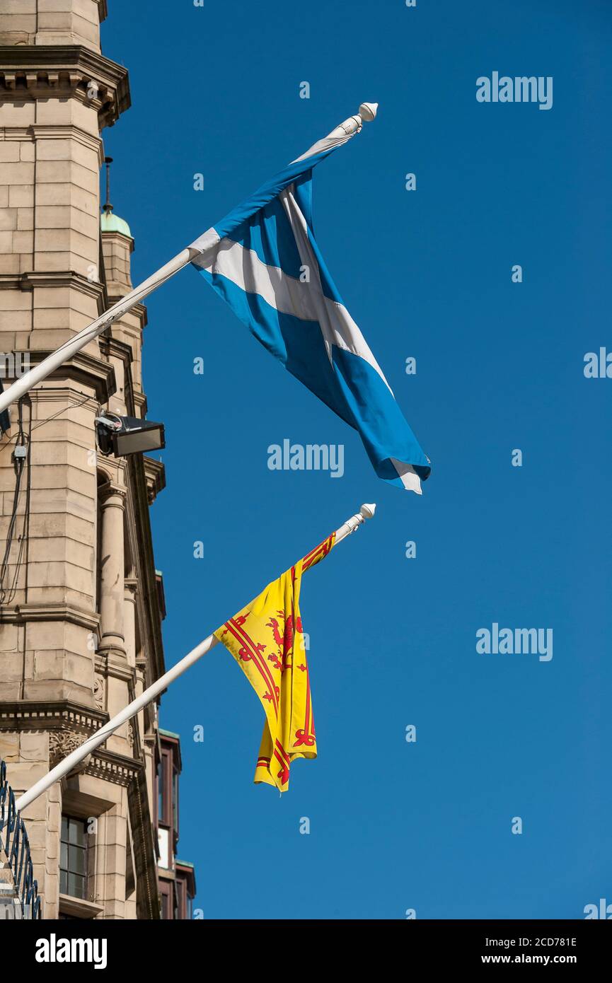 Flags flying outside buildings on Princes Street, Edinburgh, Scotland