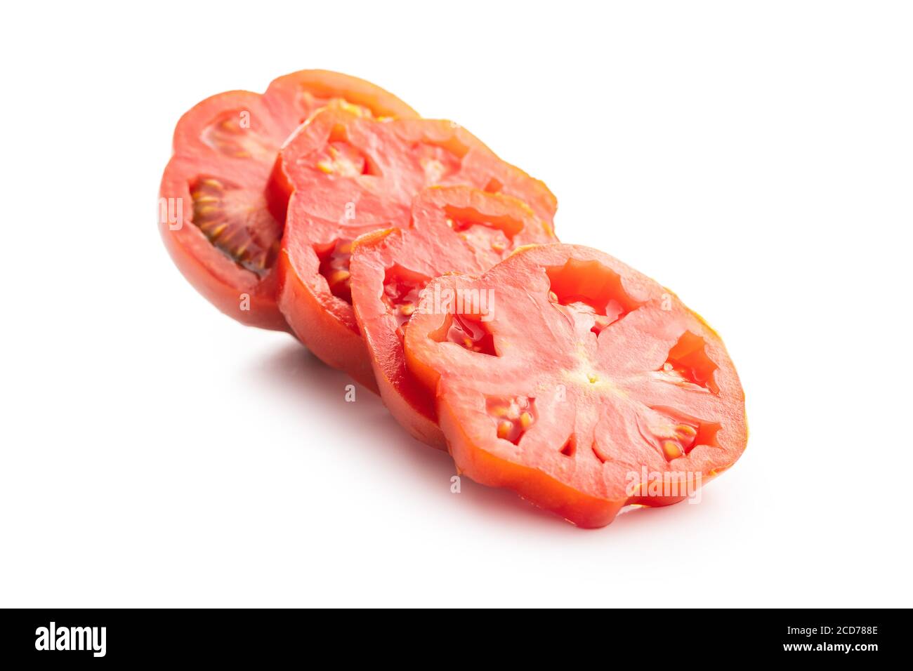 Sliced red beefsteak tomatoes isolated on white backround. Stock Photo