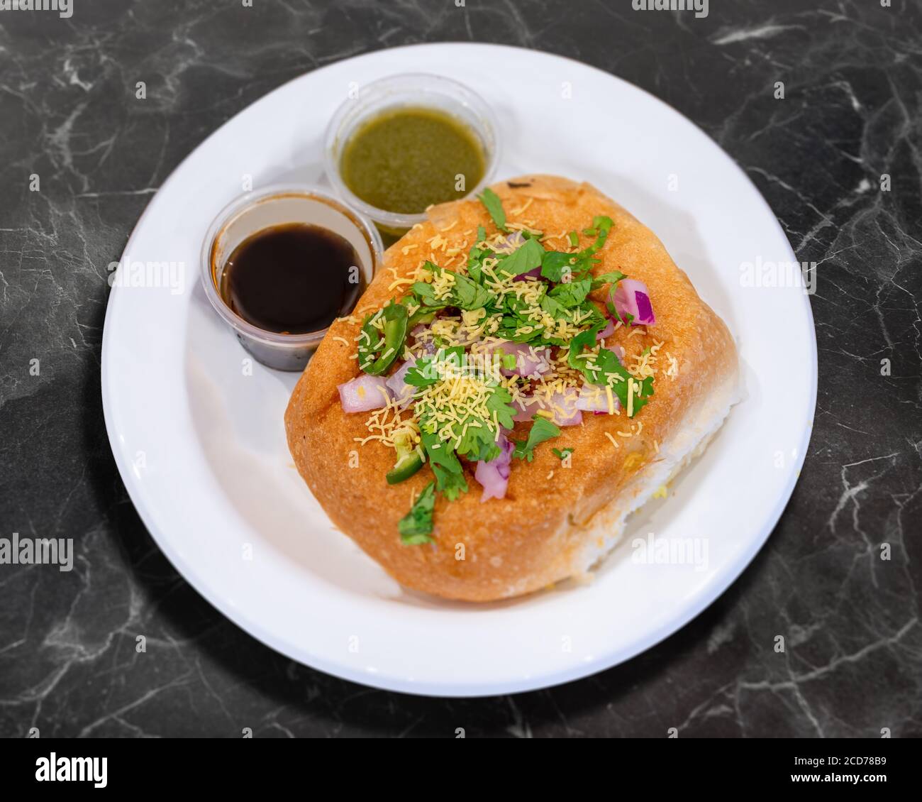 Vada Pao Bread bun Filled with Deep Fried Potato Dumpling with Sauce