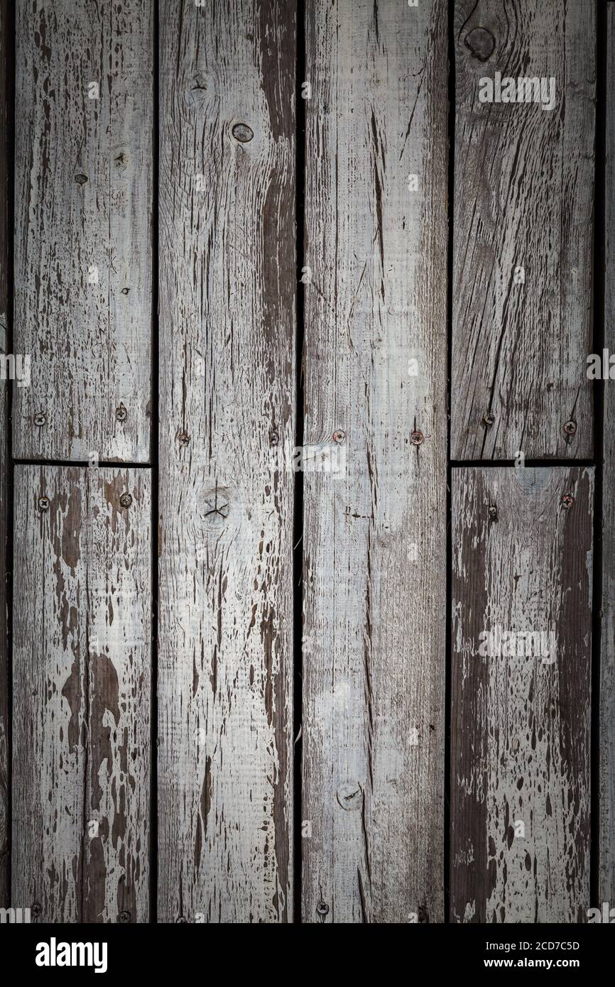 Old wooden floor with weathered and peeled white paint. Stock Photo
