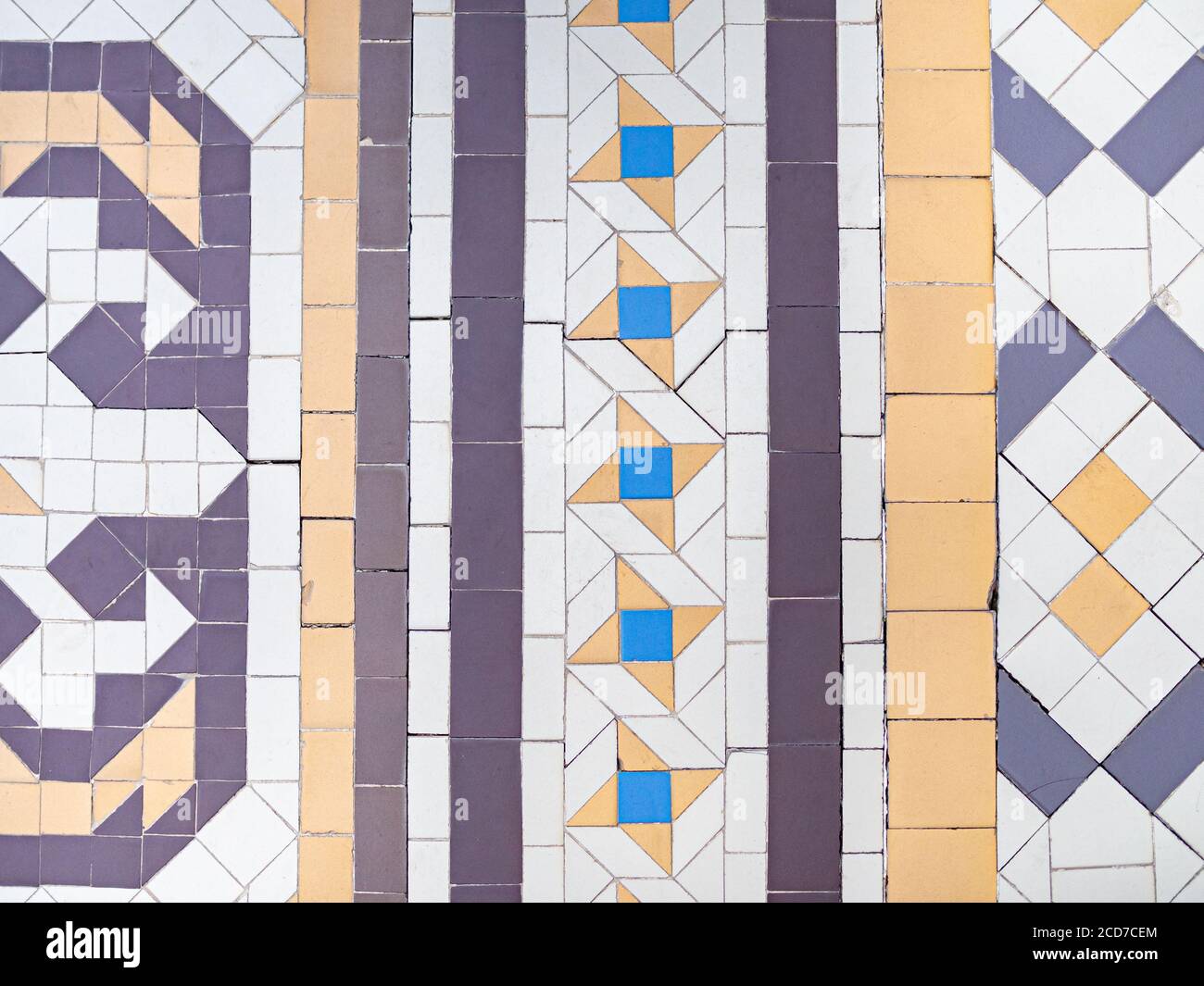 Real antique wall tiles background texture. White, blue and yellow