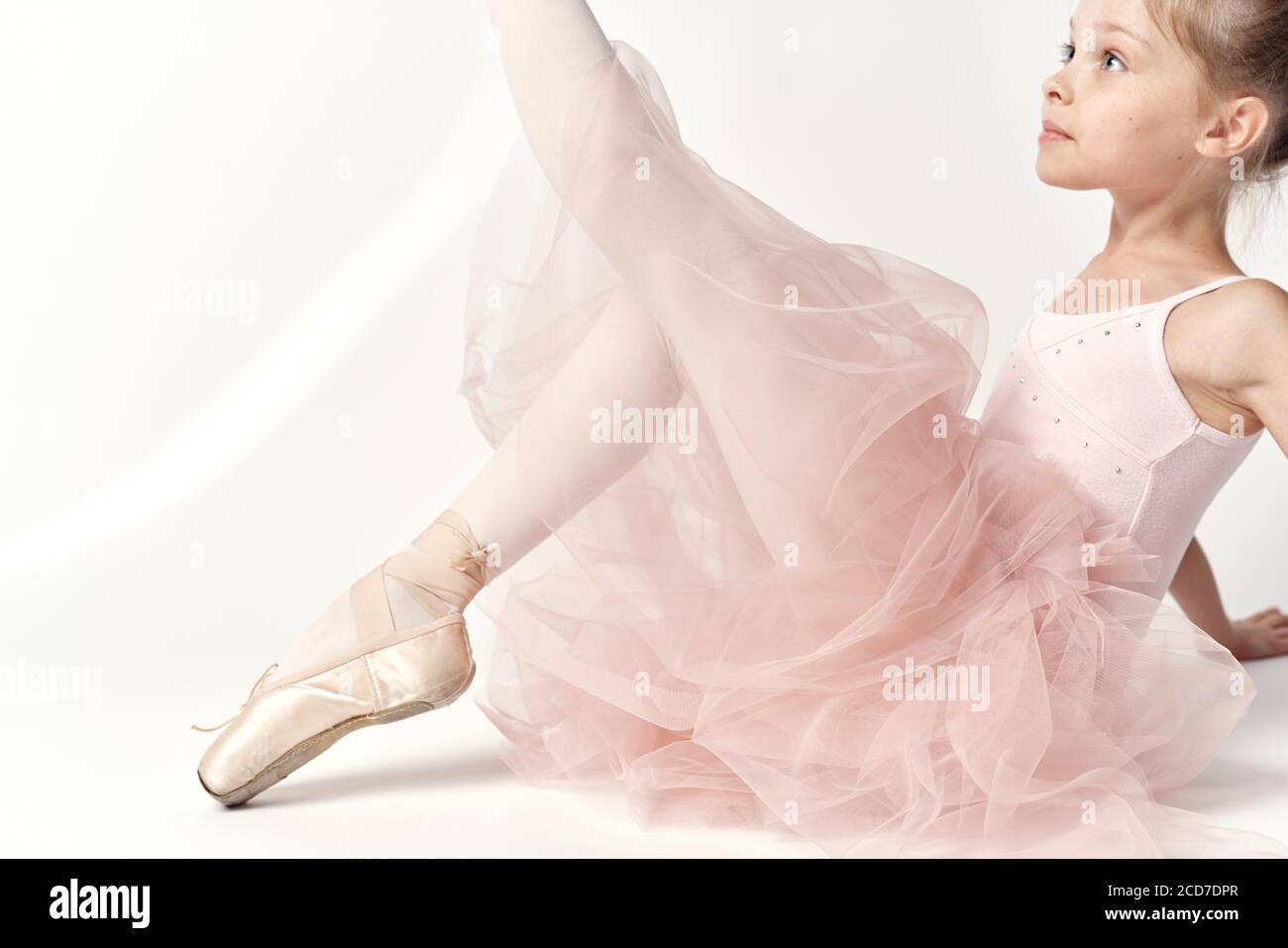 Girl ballerina in pink dance costume ballet dance pointe shoes tutu light  background model Stock Photo - Alamy