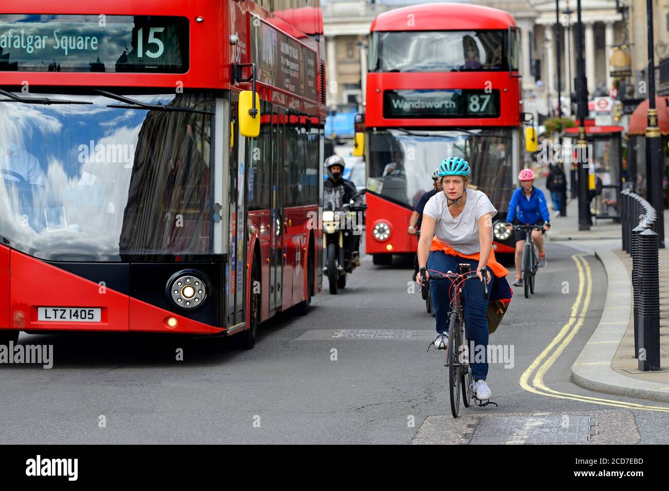 London, England, UK. Woman in a helmet riding a bike in Whitehall, Westminster Stock Photo