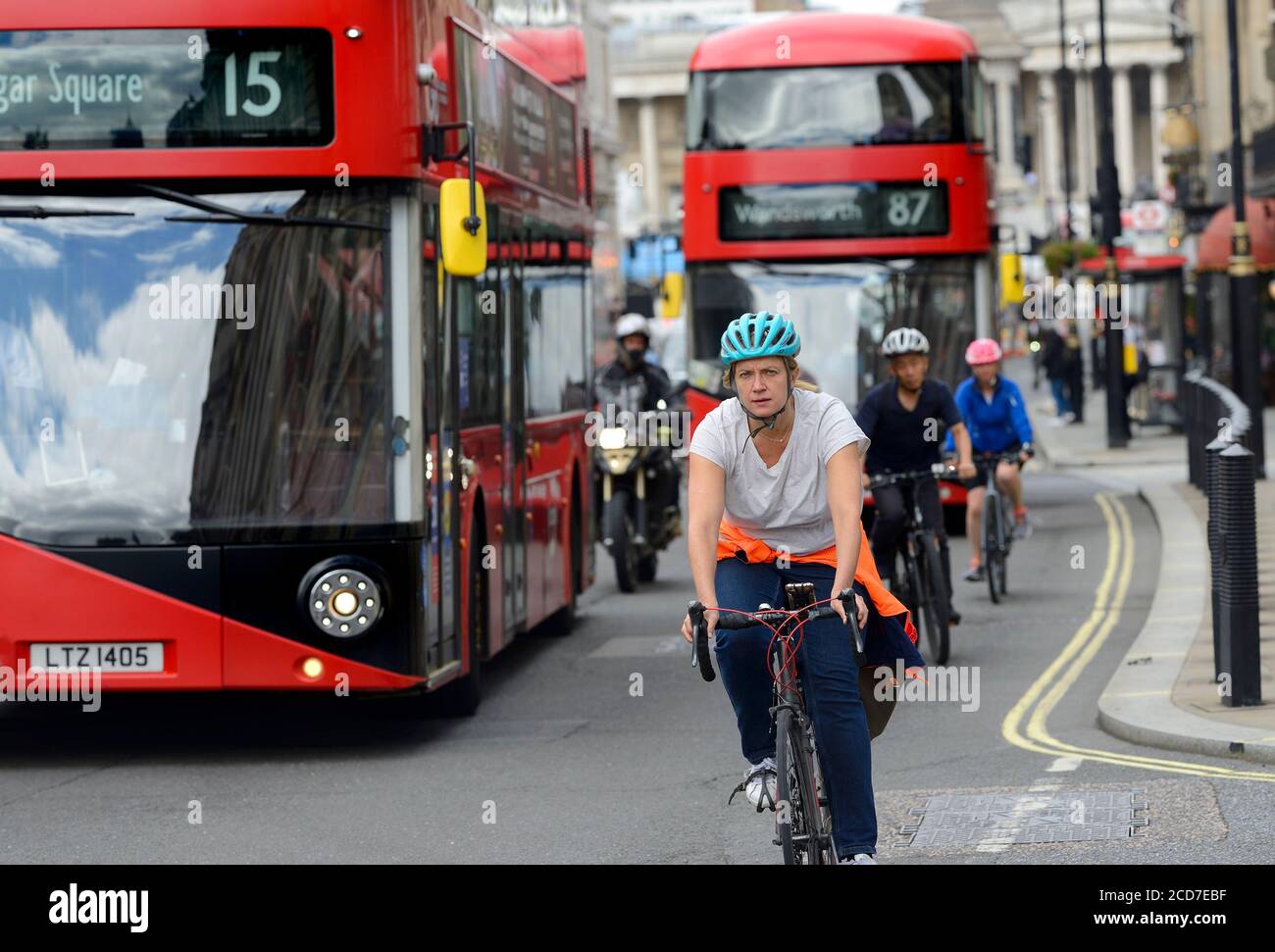 London, England, UK. Woman in a helmet riding a bike in Whitehall, Westminster Stock Photo