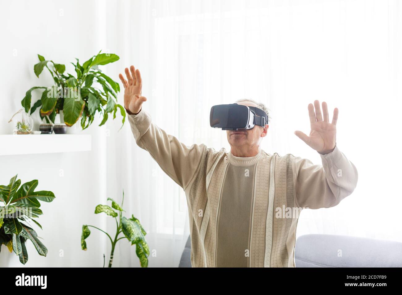 Senior man wearing virtual reality goggles at home Stock Photo Alamy