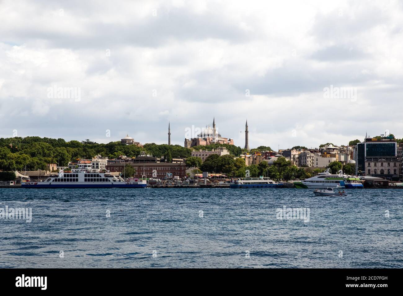 Panoramic shot of the old town Istanbul; The Hagia Sophia (Ayasofya) Mosque Eminonu, ferries and boats on the Golden Horn, Istanbul, Turkey. Stock Photo