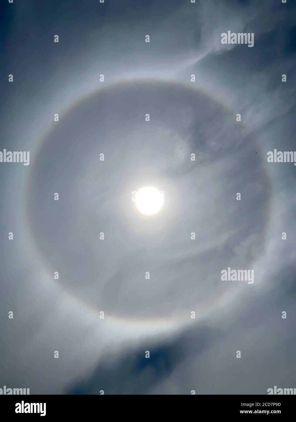 Full circle 22° halo around Sun at noon Stock Photo