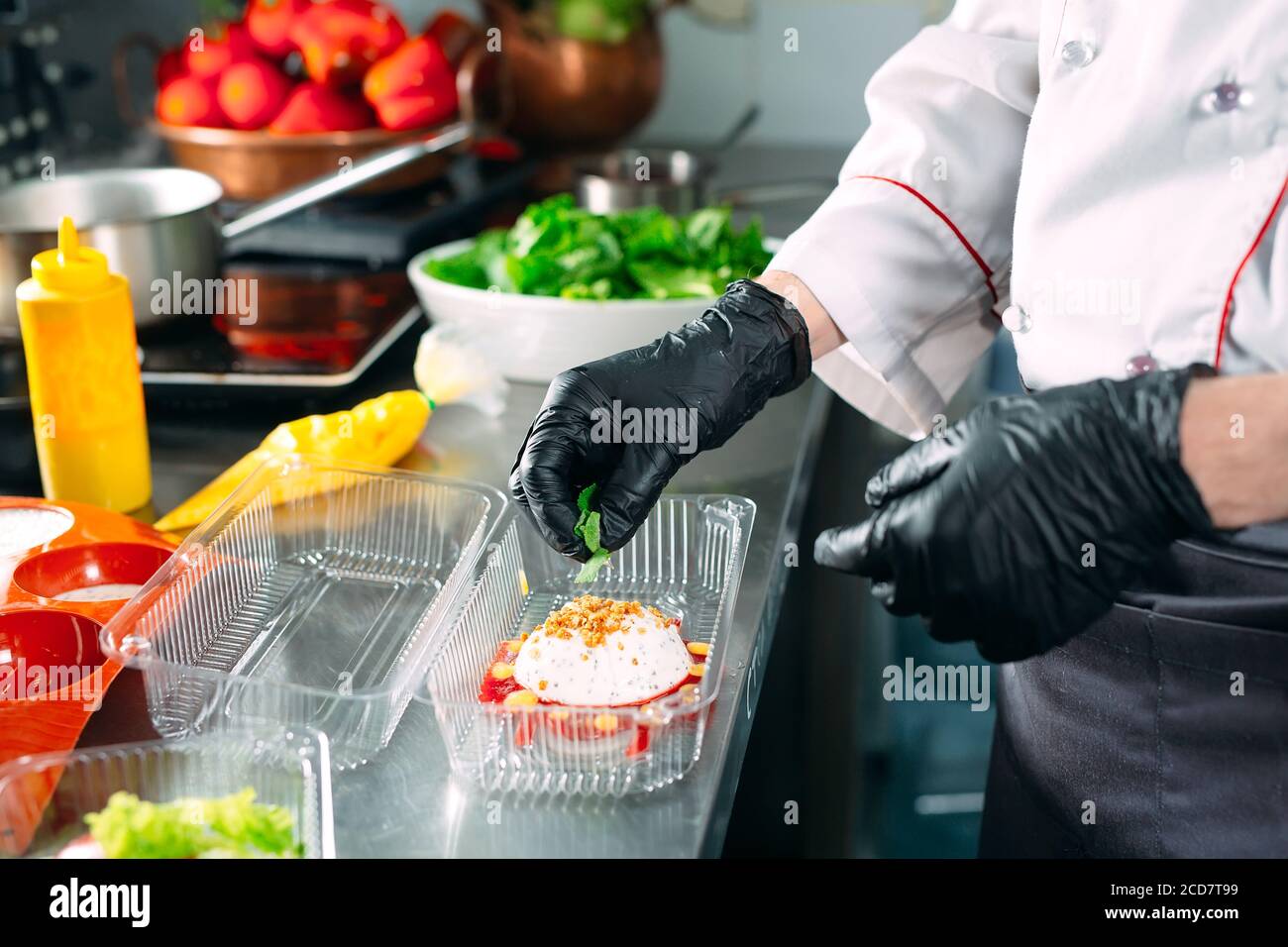 https://c8.alamy.com/comp/2CD7T99/food-delivery-in-the-restaurant-the-chef-prepares-food-in-the-restaurant-and-packs-it-in-disposable-dishes-2CD7T99.jpg