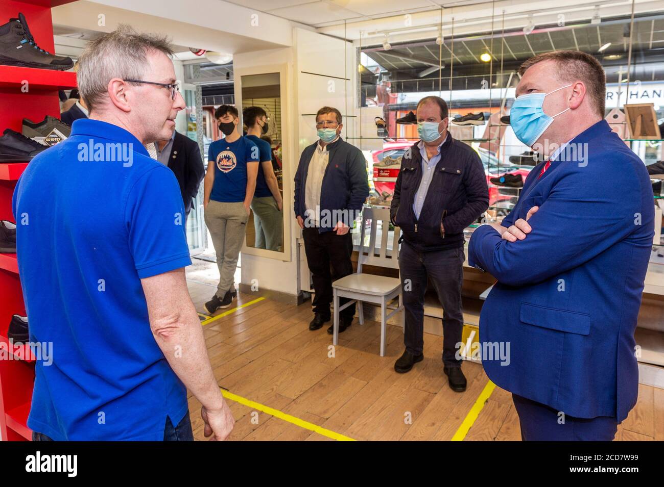 Bantry, West Cork, Ireland. 27th Aug, 2020. The Minister for Public Expenditure, Michael McGrath TD (FF), visited  Bantry today to see the flood damage caused by Storm Francis on Monday last. Minister McGrath speaks to Gearoid Wiseman of Wiseman's Shoe Shop. Credit: AG News/Alamy Live News Stock Photo
