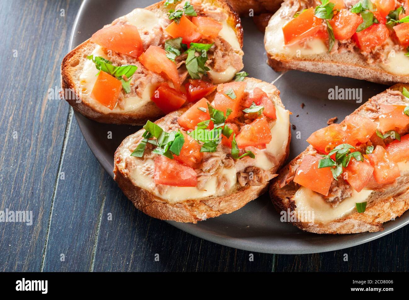 Appetizer bruschetta with tuna, mozarella cheese and tomatoes. Italian cuisine Stock Photo