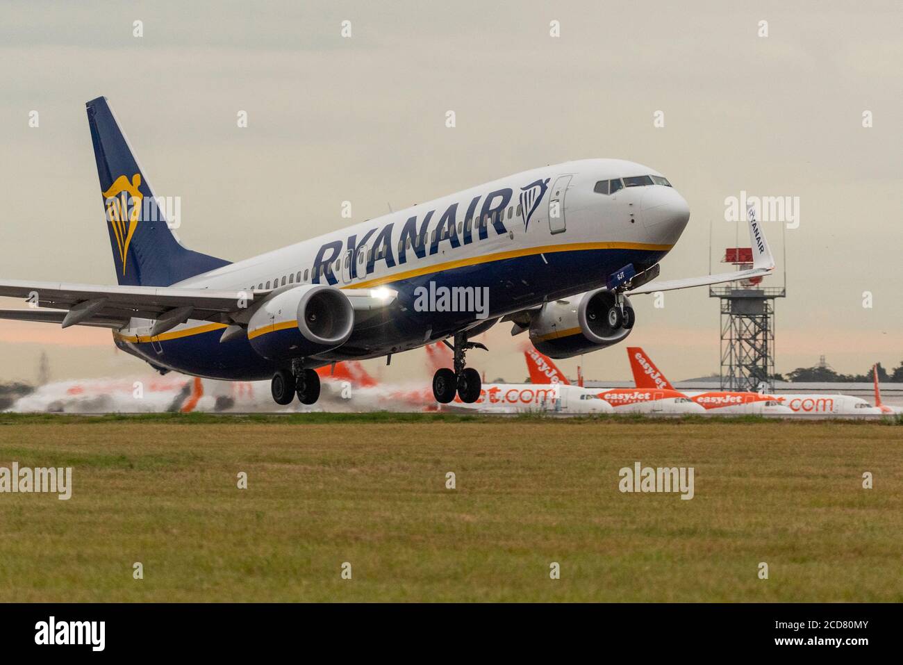 Ryanair Boeing 737 jet airliner plane taking off for Bilbao, Spain, over stored easyJet planes grounded due to COVID-19 at London Southend Airport Stock Photo