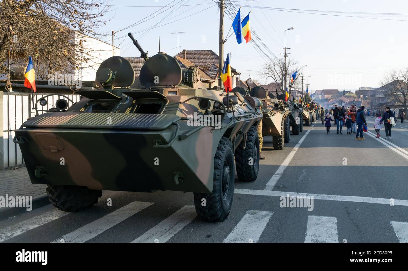 Alba Iulia, Romania - 01.12.2018: Column of APC's ornated with Romanian flags on the street Stock Photo