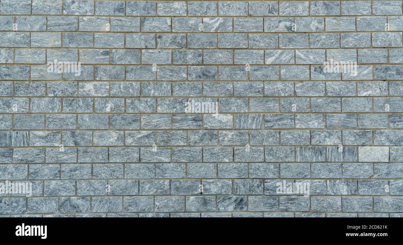 wall is lined with gray marble tiles. Stock Photo