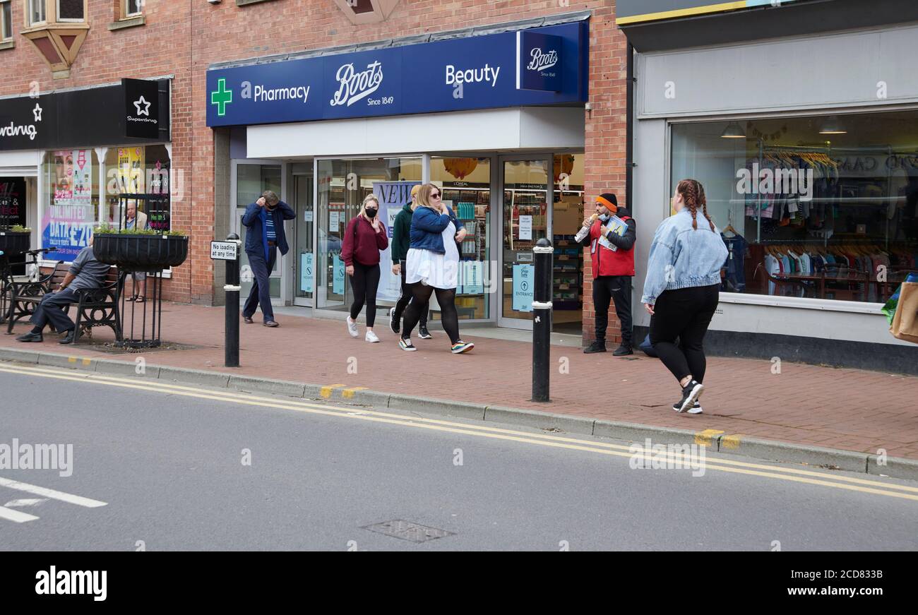 Boots the chemist with shoppers outside on the high street, Driffield