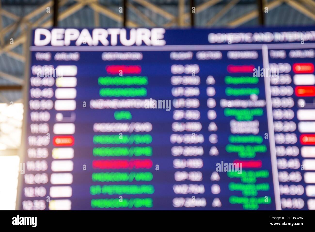 Airport departure board, view out of focus Stock Photo