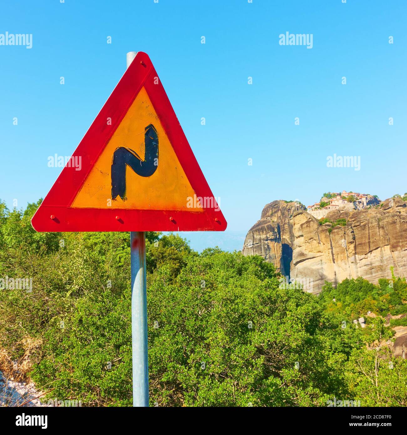 Winding Road sign at mountain spiral highway Stock Photo