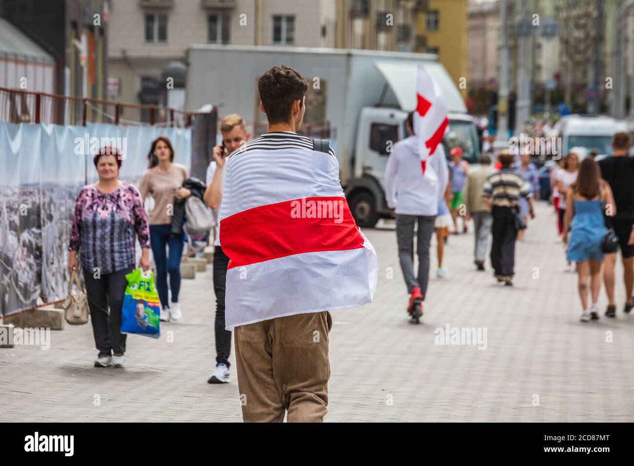 Man wears flag during peaceful protests against stolen presidential elections in Minsk, Belarus. Minsk, Belarus - August 15 2020. Stock Photo