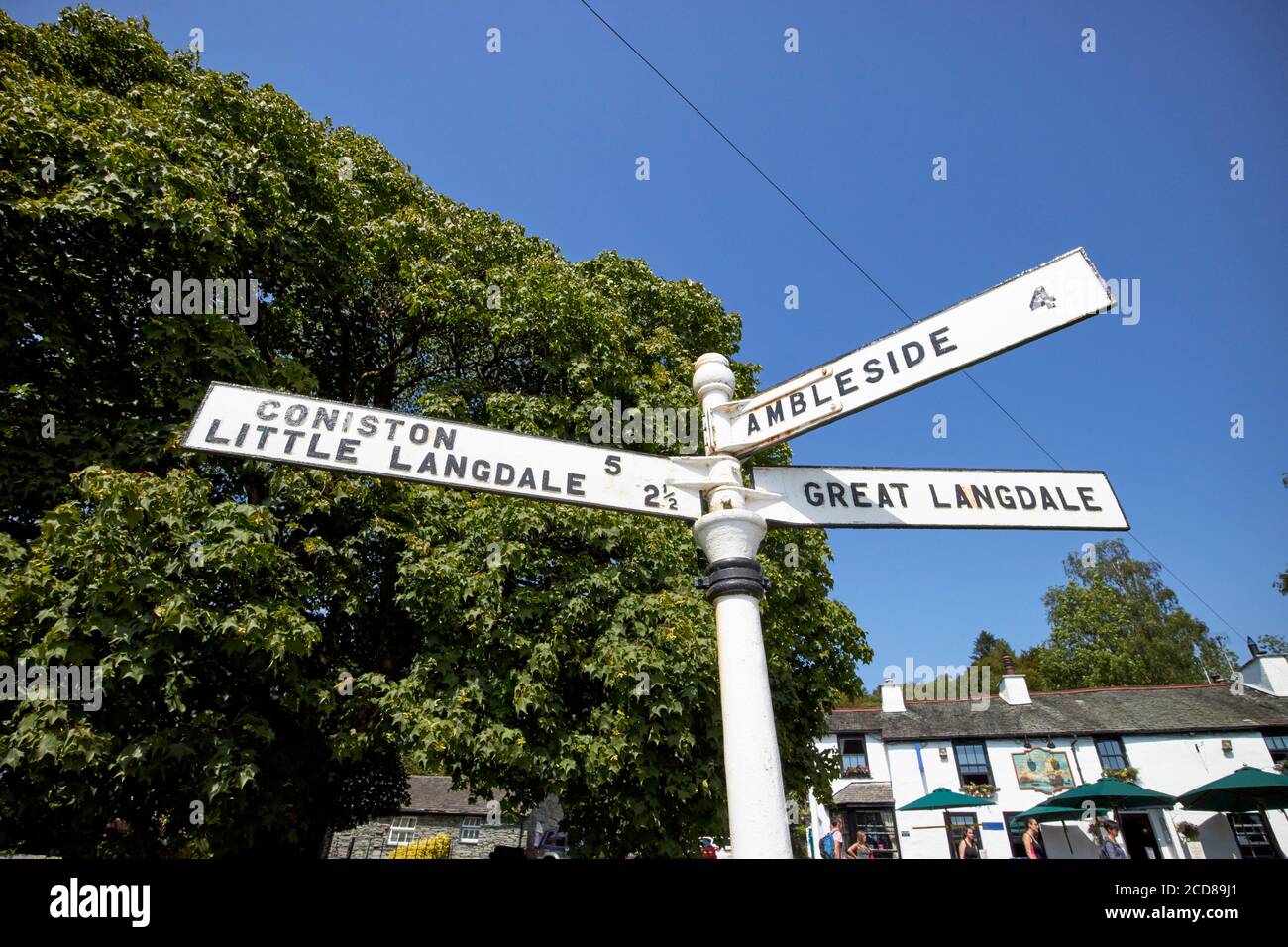 old metal signpost with directions and distances to ambleside coniston