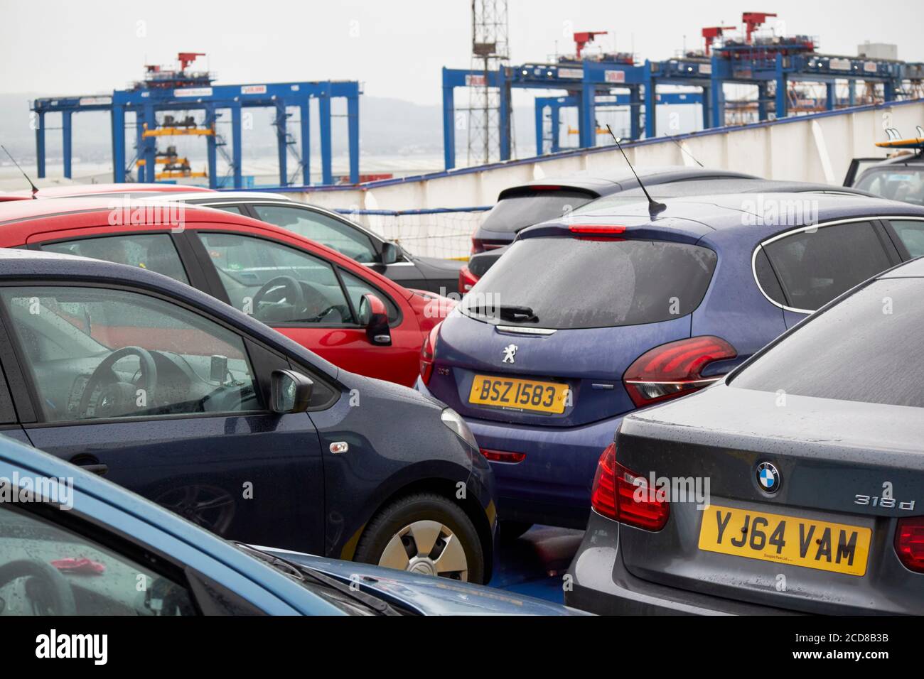 cars parked on a ferry docking in the port of belfast northern ireland