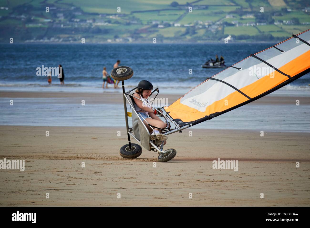 young woman driving blokart at speed tipping over compact land yachts on benone beach northern ireland uk Stock Photo