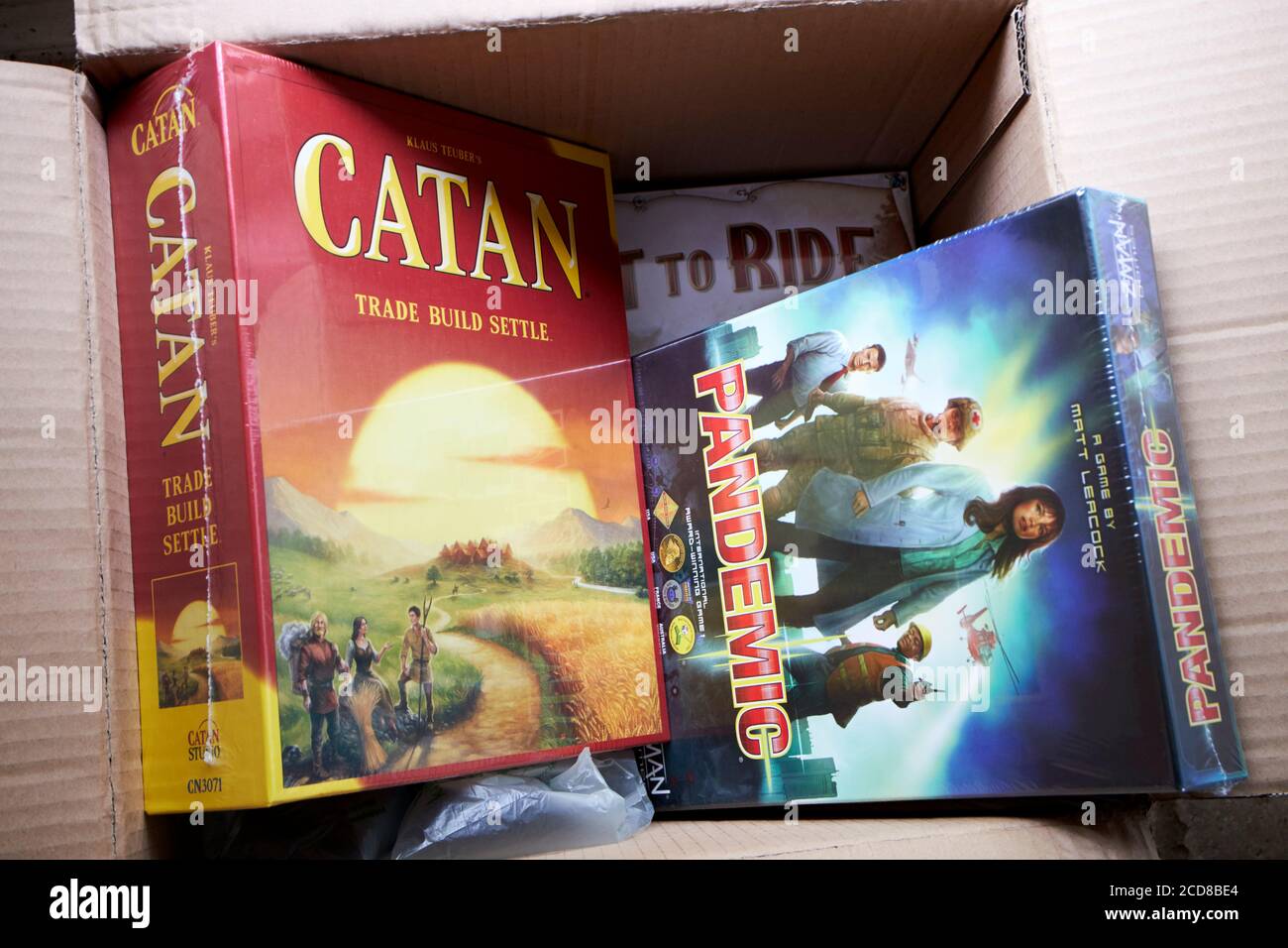 home delivery of new board games pandemic catan and ticket to ride during coronavirus lockdown in the uk Stock Photo