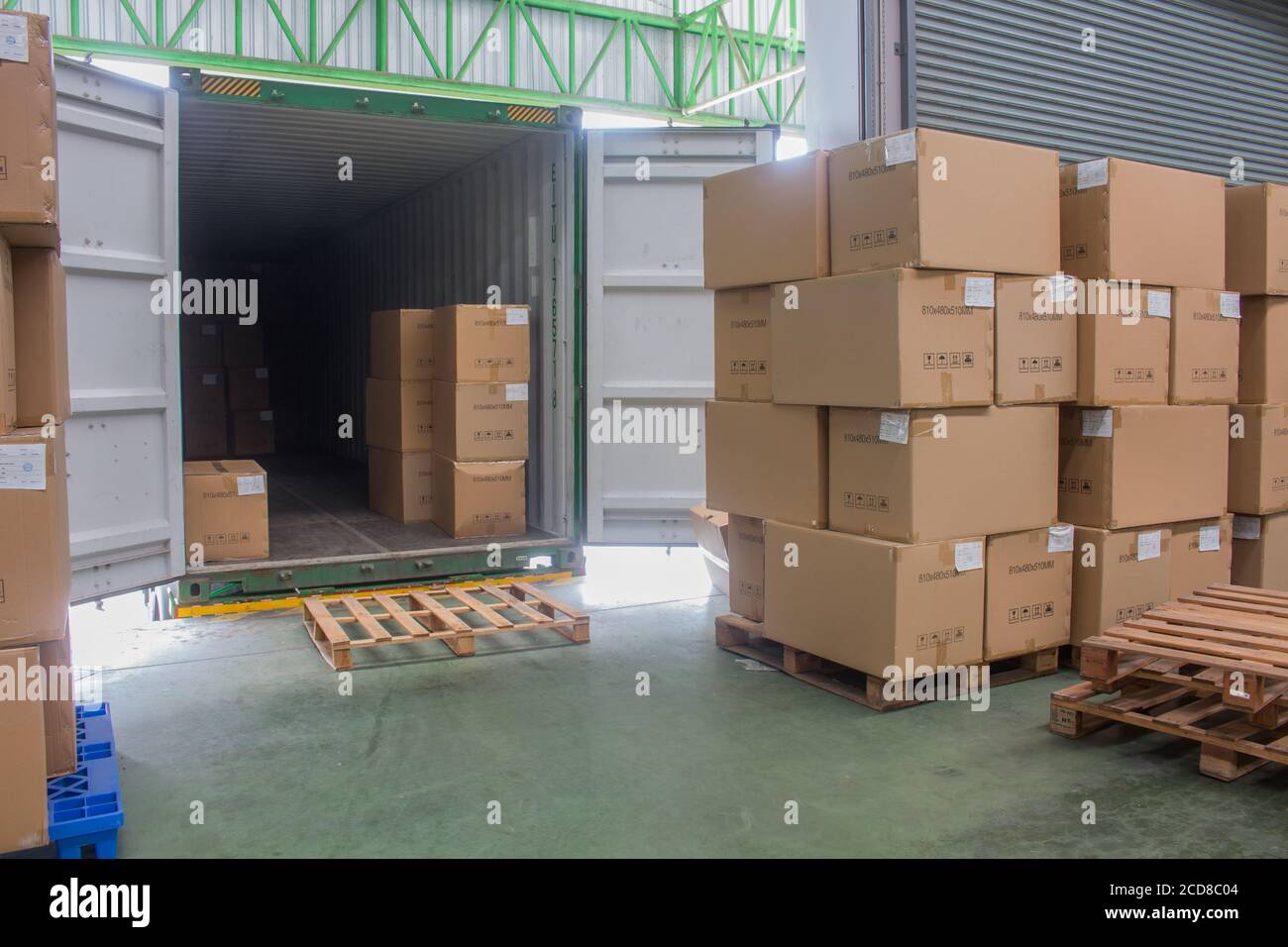 loading shipment carton boxes and goods on wooden pallet at loading dock  from container Stock Photo - Alamy