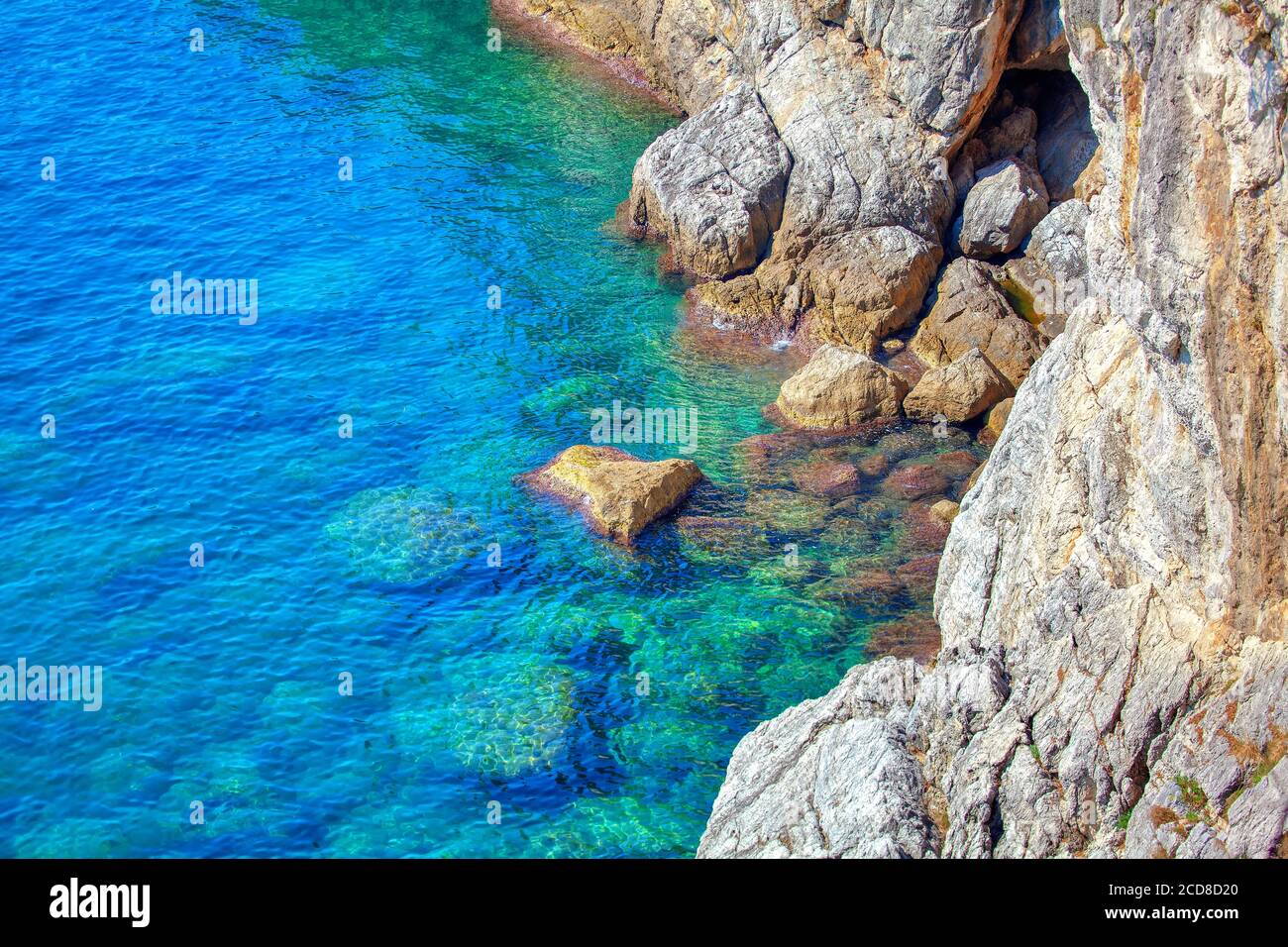 Rocky coastal formation . Transparent sea water with stones on the ...
