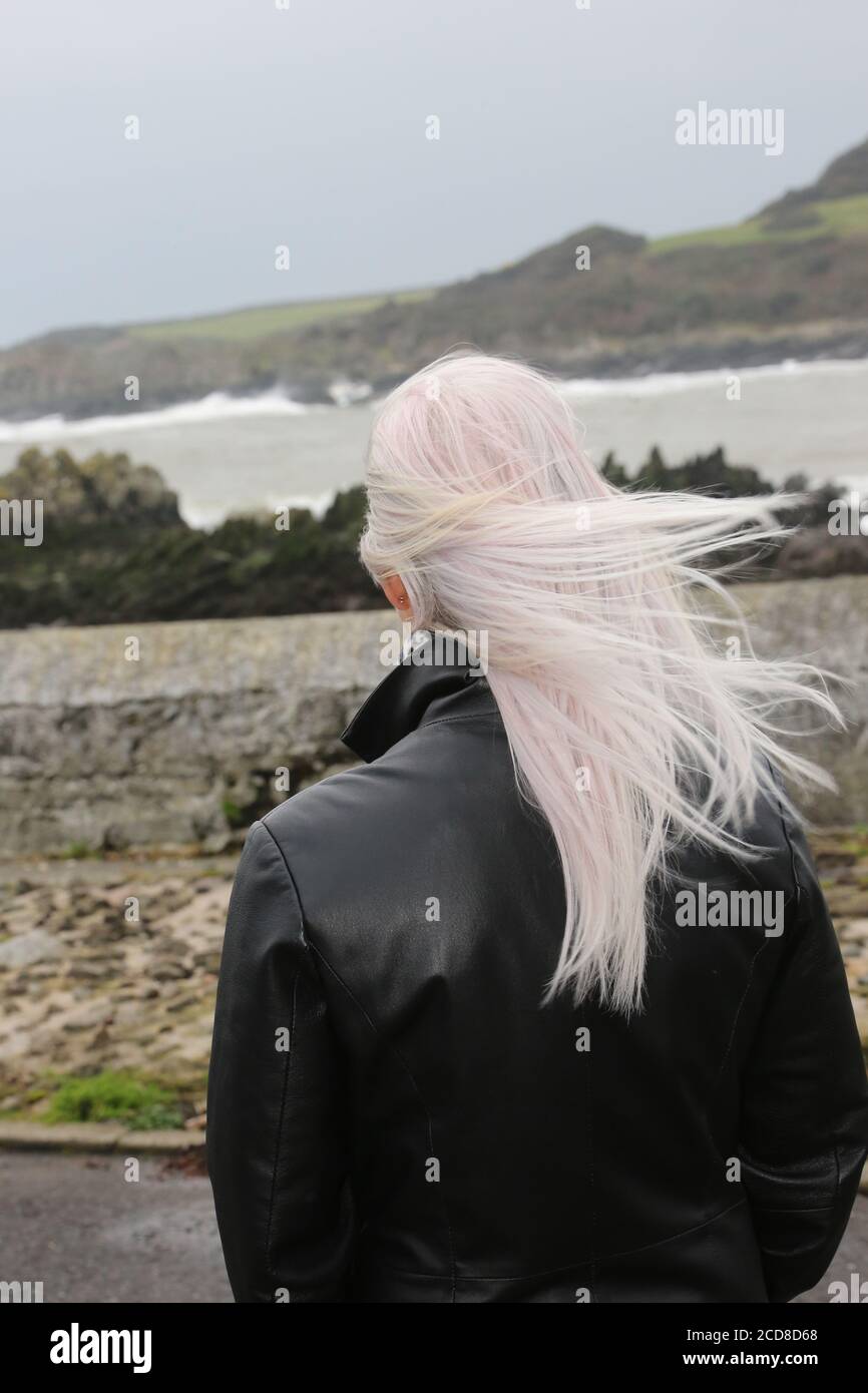 Caucasian white middle aged woman in long leather coat ,collar turned